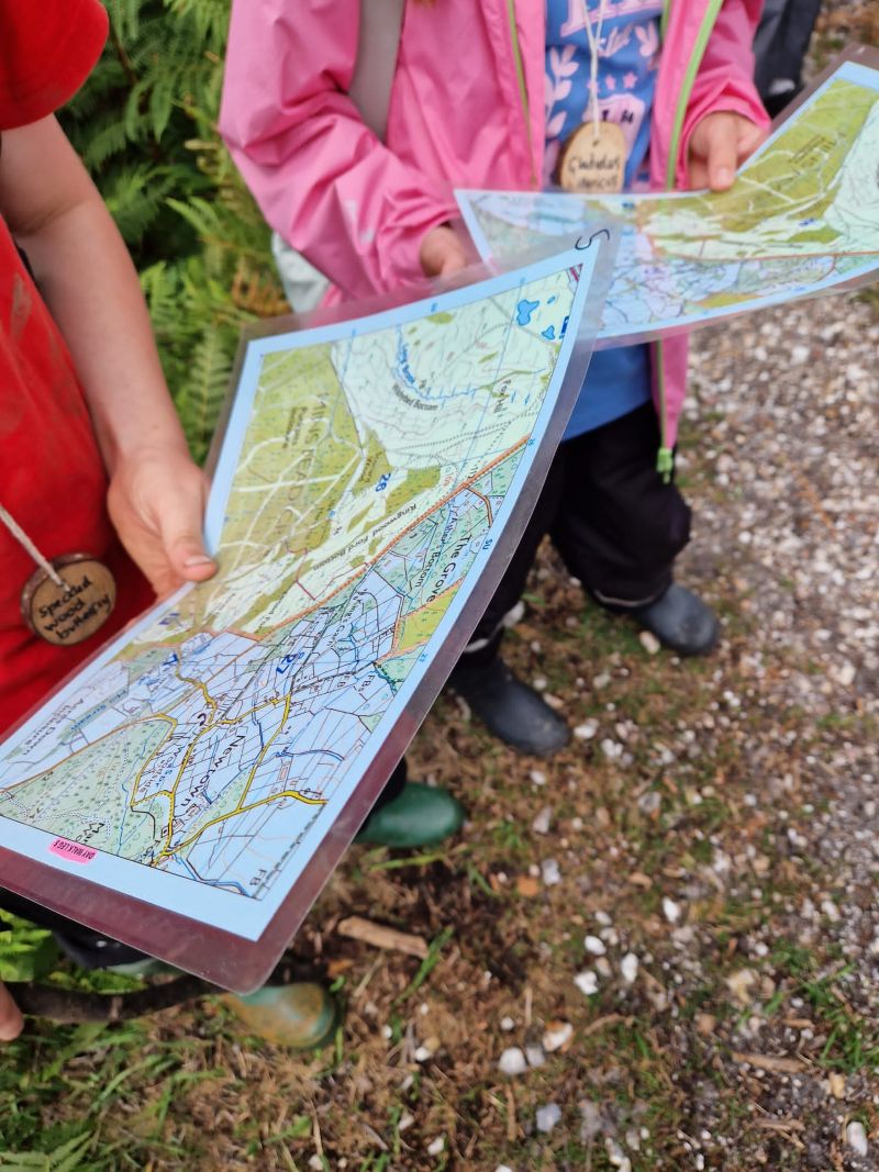 Children holding Ordnance Survey maps