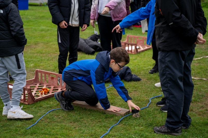 Children busy with an outdoor teamwork activity