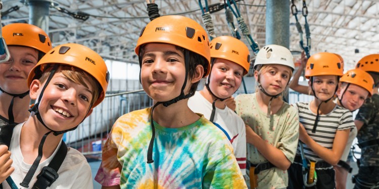 Group of children in hard hats and harnesses