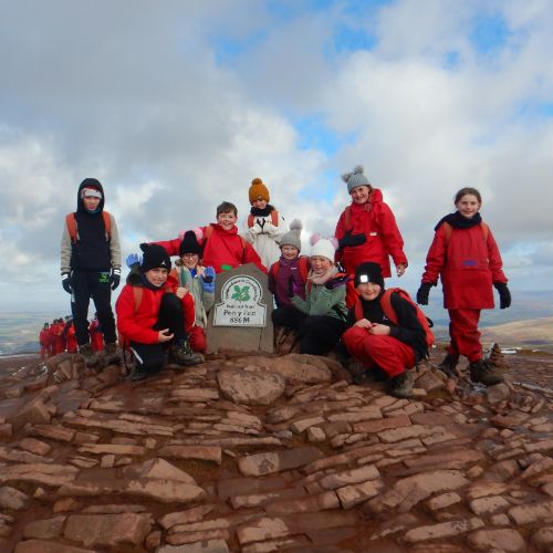 school children at a mountain peak