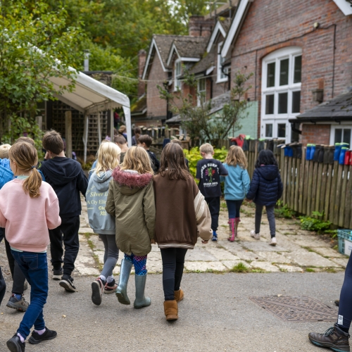 Group of children walking towards a building at Minstead