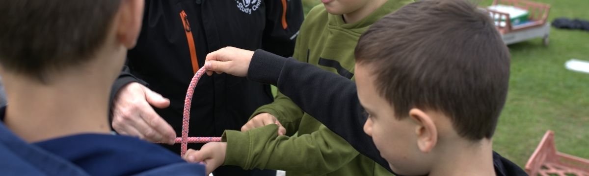 Children and an instructor working with some rope