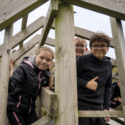 Children climbing in a wooden structure