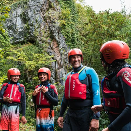 a group of people wearing lifejackets and helmets