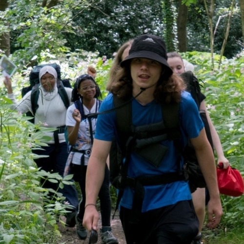 School group cheering on top of a hill