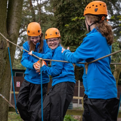 Young people completing an assault course