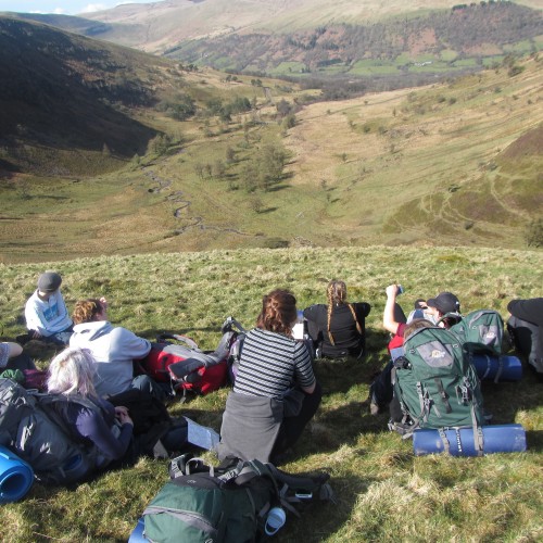 School group cheering on top of a hill