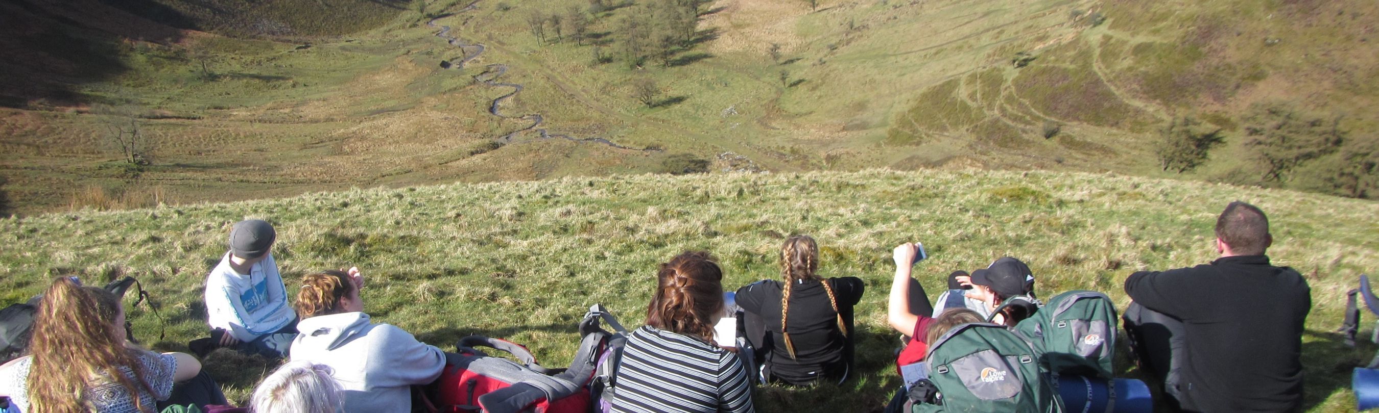School group cheering on top of a hill