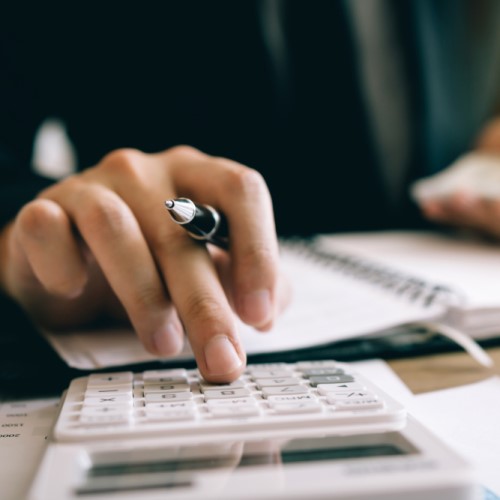  A close up of someone's hand using a calculator