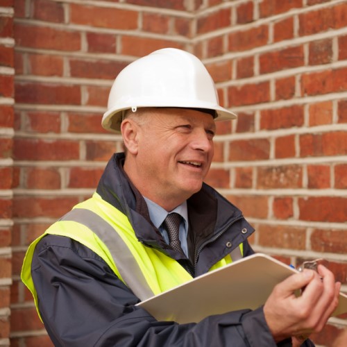  a man in safety clothing with a clipboard