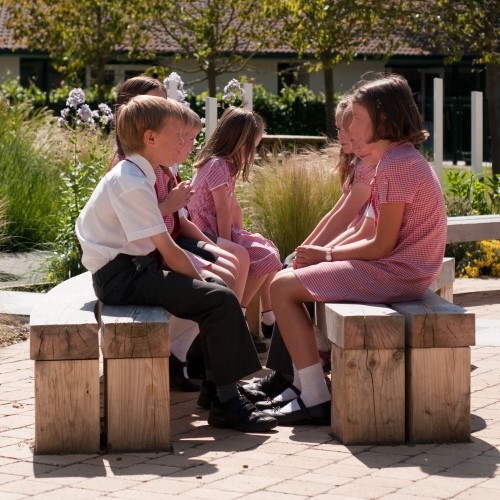  school children sat talking on benches