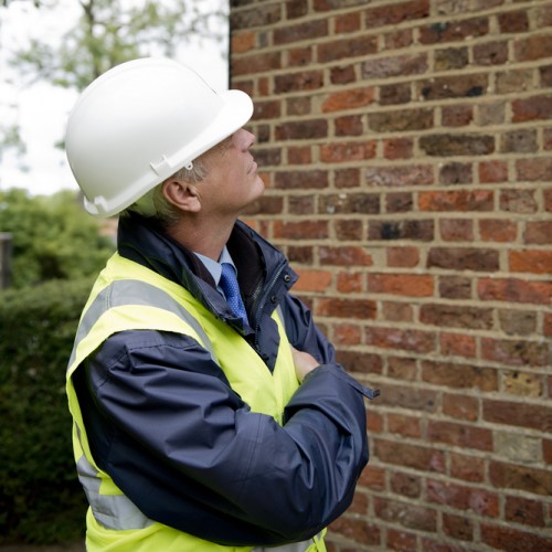  surveyor examining brickwork