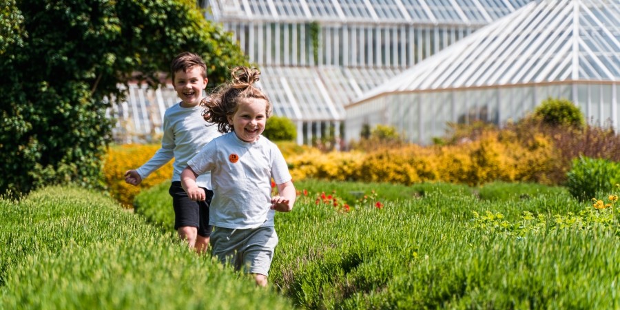 Children running through the gardens at Staunton Farm