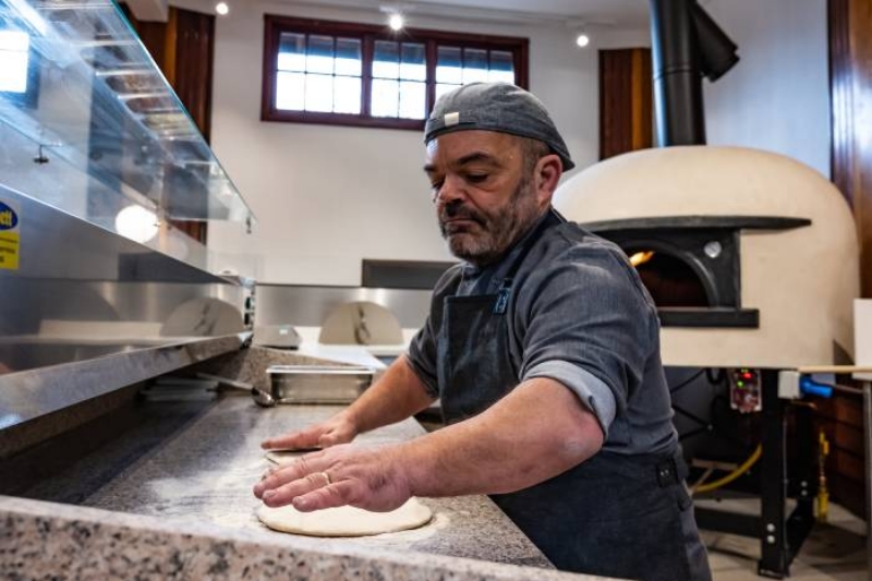 a chef holding freshly baked cakes