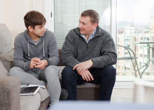 Man talking to teenager