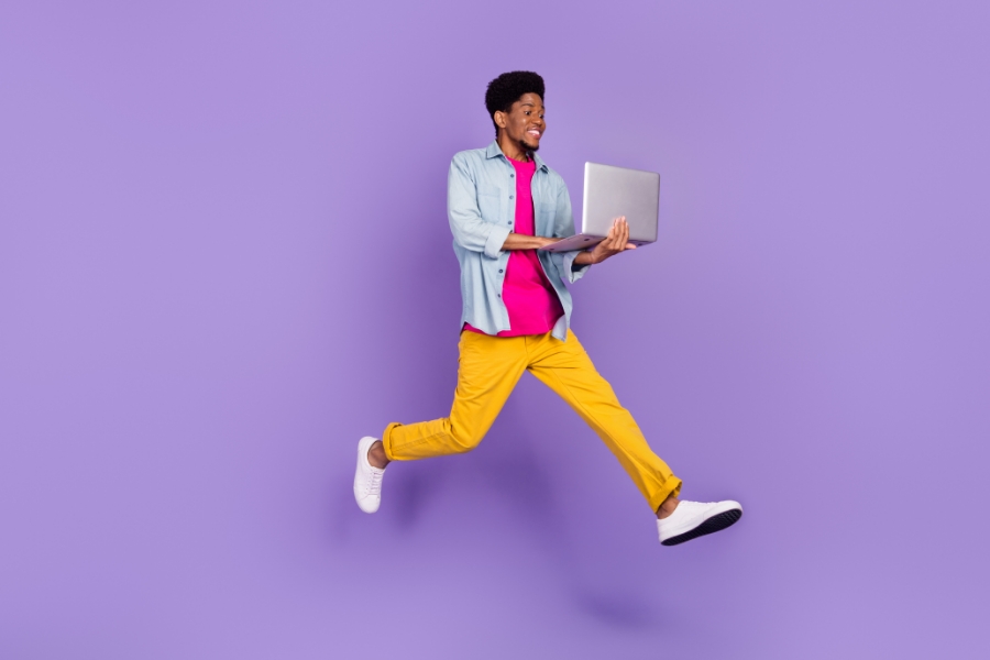 boy jumping with laptop 