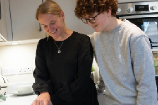Two women smiling and holding a toddler