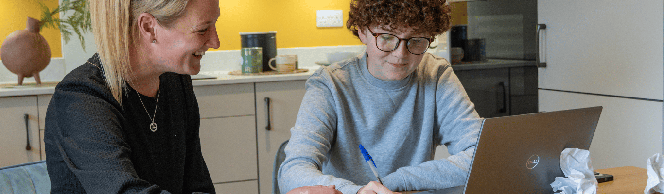 A foster carer helping a child with homework