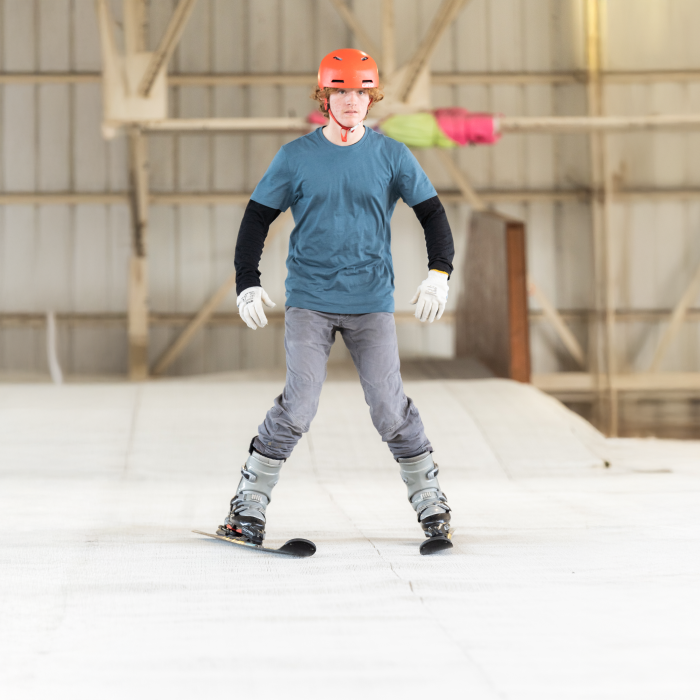 Man skiing down an indoor slope