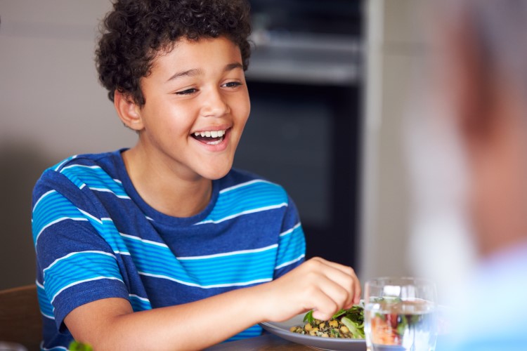Boy eating a plate of healthy food